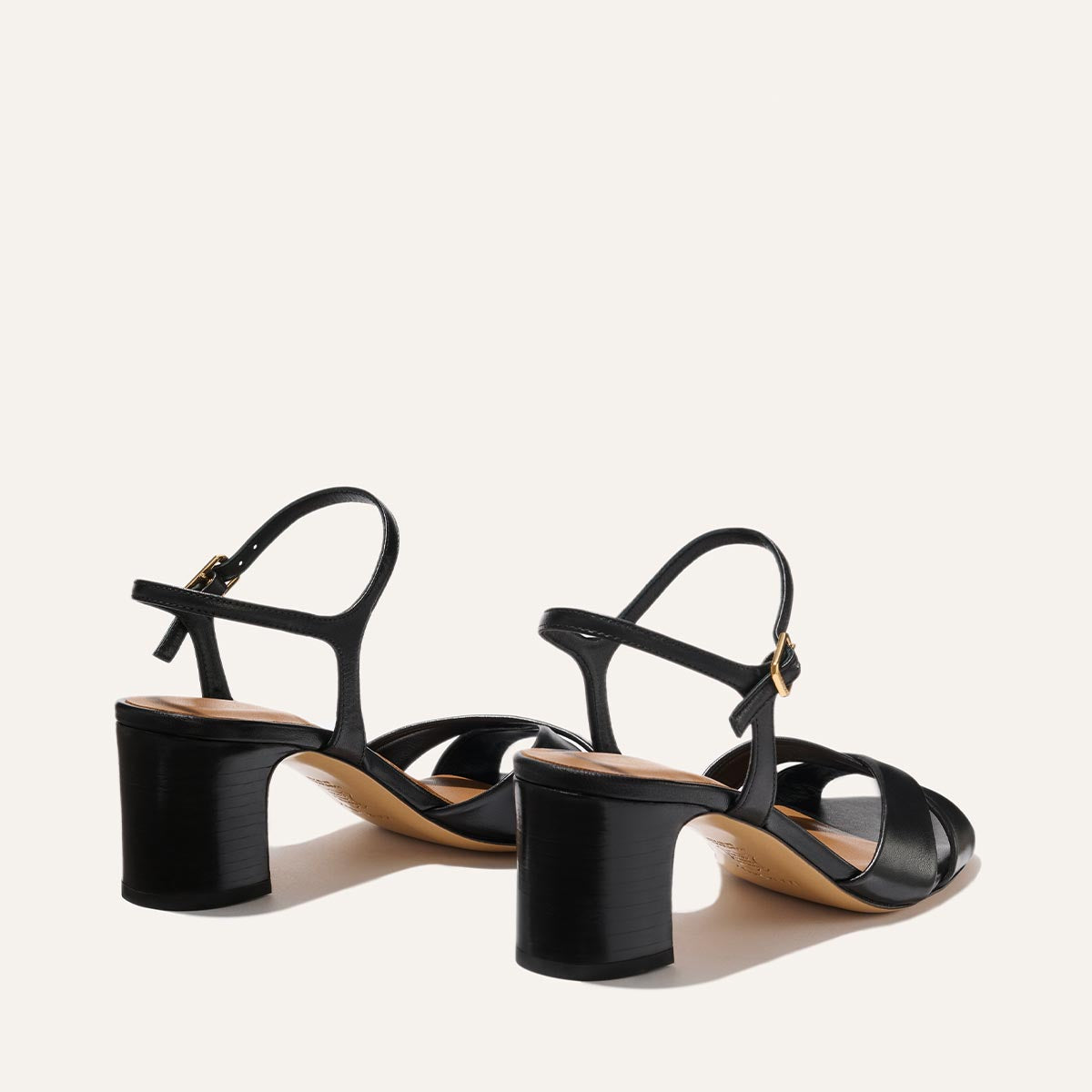 The Paloma Sandal by Margaux in Black Nappa features open toes, strappy design, medium block heels, and ankle straps, shown against a plain light background.