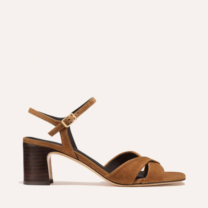 The Paloma Sandal by Margaux in Nutmeg Suede features leather straps, a crisscross front, ankle strap with buckle, and a 2.5-inch stacked block heel—perfect for everyday wear. Shown on a plain light background.