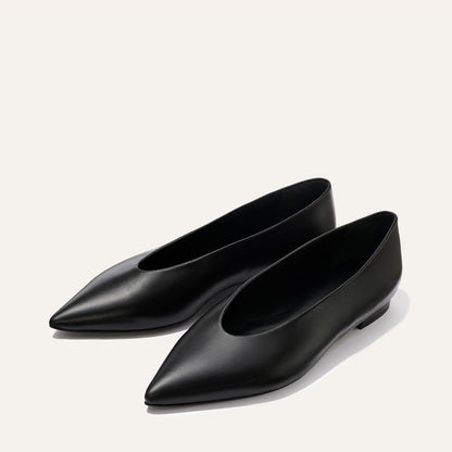 The Parra - Black Nappa by margaux-development: smooth black leather pointed-toe flats with a minimalist design, shown on a light background and free of embellishments.