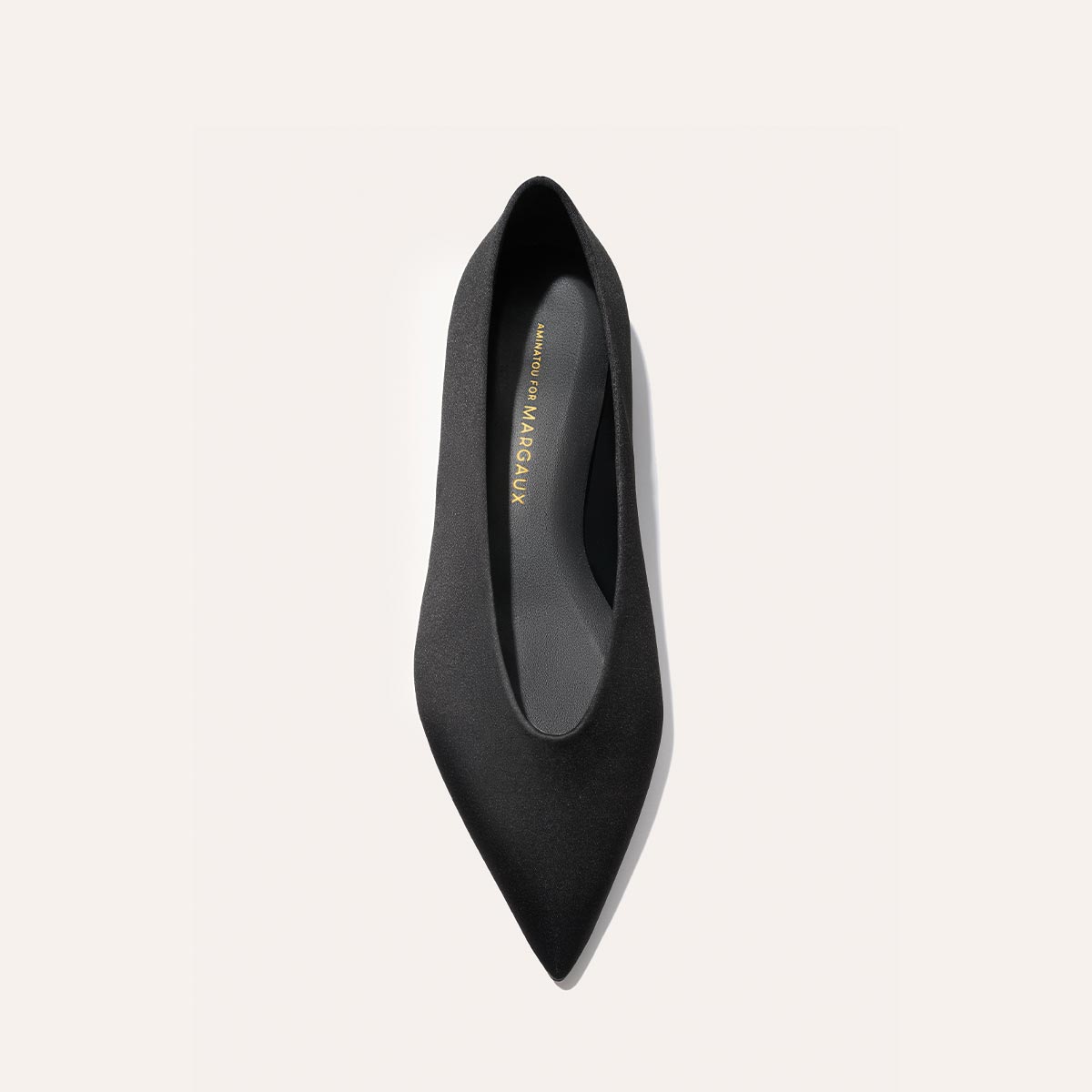 A top-down view of The Parra - Black Satin pointed-toe flat by margaux-development, set against a plain white background.