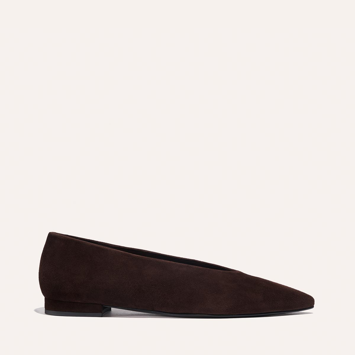The Parra - Espresso Suede by margaux-development is shown in side profile against a light background, featuring dark brown suede, a low heel, almond toe, and minimalist design.