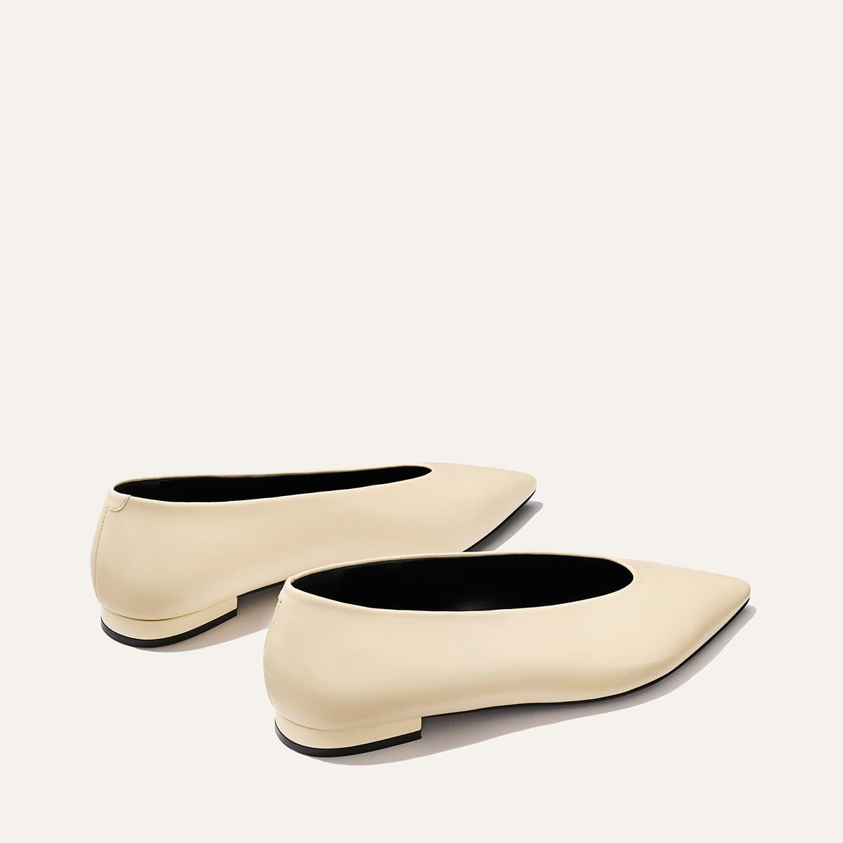 The Parra - Ivoire Nappa by margaux-development: cream-colored, pointed-toe ballet flats with low heels shown on a simple, light background.