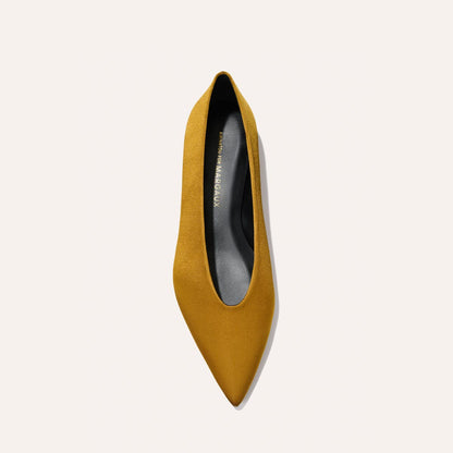 Top view of The Parra - Ochre Satin pointed-toe flat shoe by margaux-development, featuring a mustard yellow satin finish and black insole, displayed on a plain light background.