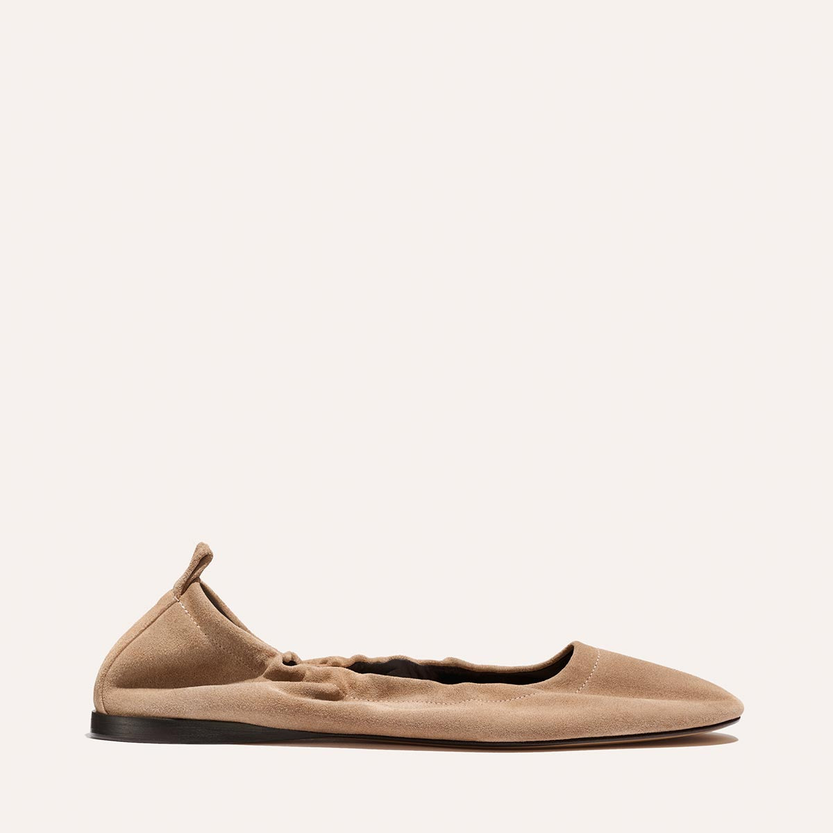 The Pascale - Cameo Suede by Margaux is a tan suede ballet flat featuring gathered, elasticized sides and a pull tab at the heel, shown in profile against a plain light background.