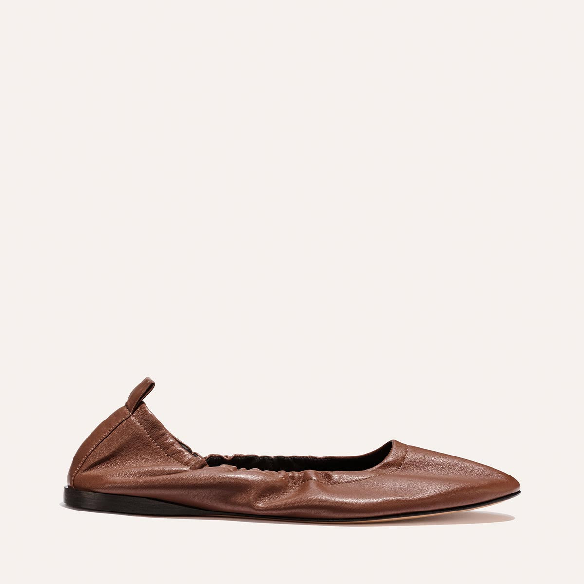 The Margaux "Pascale" in Cognac Nappa: a brown leather ballet flat with a pointed toe, elasticized sides, and heel tab, shown on a plain white background.