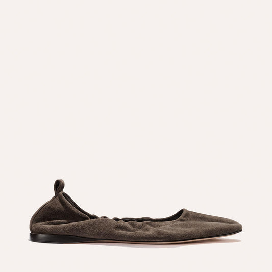 The Pascale - English Brown Suede by Margaux is a single dark brown suede ballet flat, featuring a softly ruched design, black sole, and an elasticated back with a small pull tab at the heel, displayed against a plain light background.