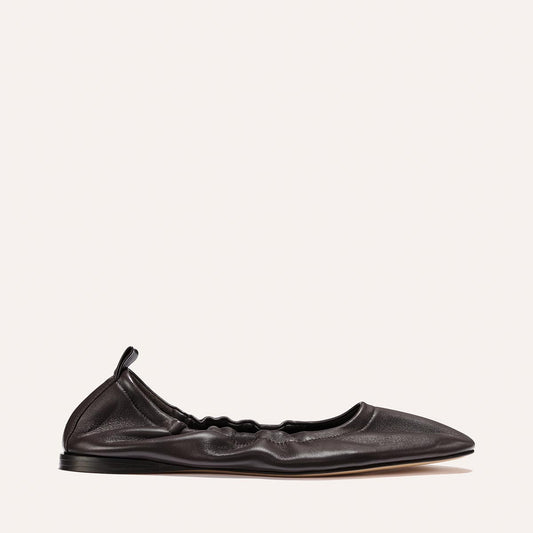 The Pascale - Espresso Nappa by Margaux is a black leather deconstructed ballet flat crafted from supple leather, featuring a ruched, gathered design with a pointed toe and an elasticated back with a small pull tab, displayed against a plain light background.