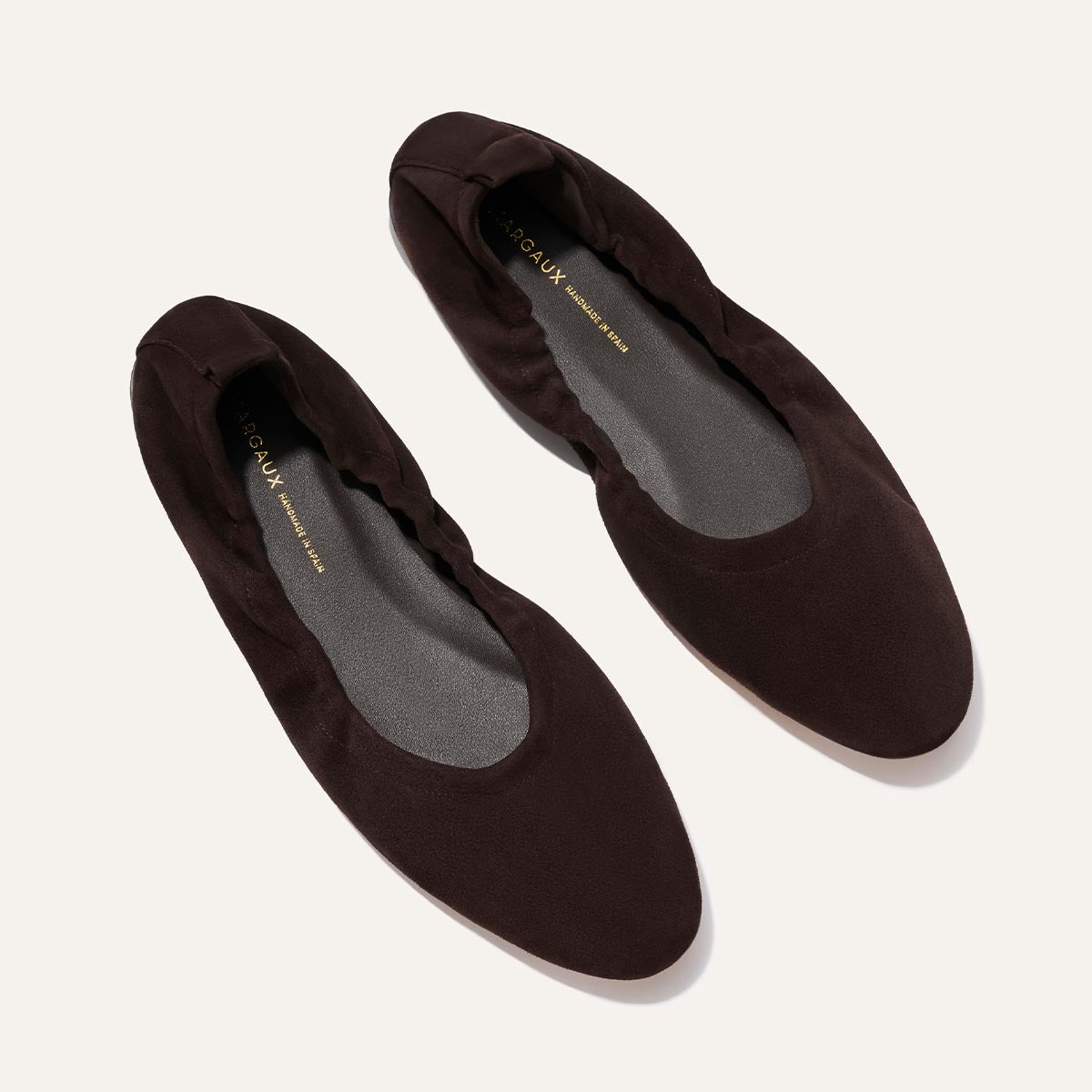 The Pascale - Espresso Suede by Margaux: dark brown ballet flats with round toes, soft and stretchy uppers, and black insoles, shown on a light background.