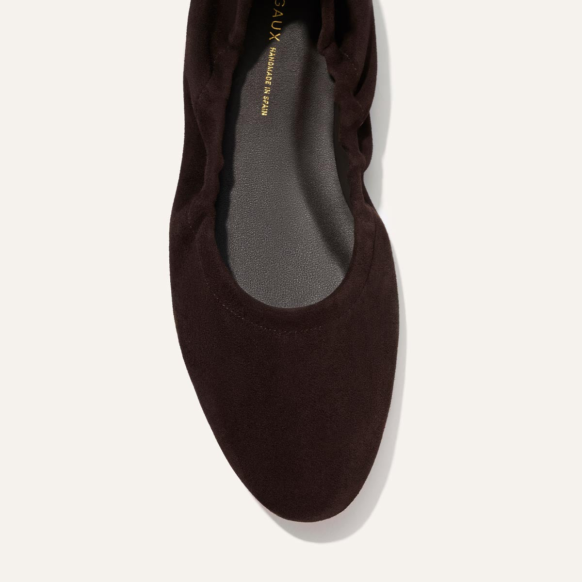 Top view of The Pascale - Espresso Suede by Margaux, a single dark brown suede ballet flat featuring a rounded toe and slightly gathered edge.