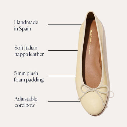 The margaux-development Demi - Butter Nappa ballet flat, shown from above, features soft Italian nappa leather in a cream hue, handmade in Spain with 5 mm plush foam padding and an adjustable cord bow for extra comfort.
