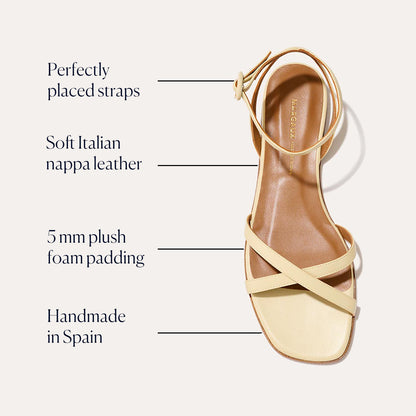 The Flat Sandal - Butter Nappa by Margaux features thin ankle and toe straps in soft Italian nappa leather, 5mm plush foam padding for comfort, and is handmade in Spain—luxurious details in every pair.