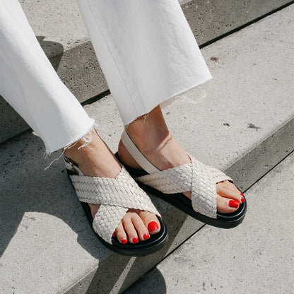 Woman wearing ecru leather petra sandals