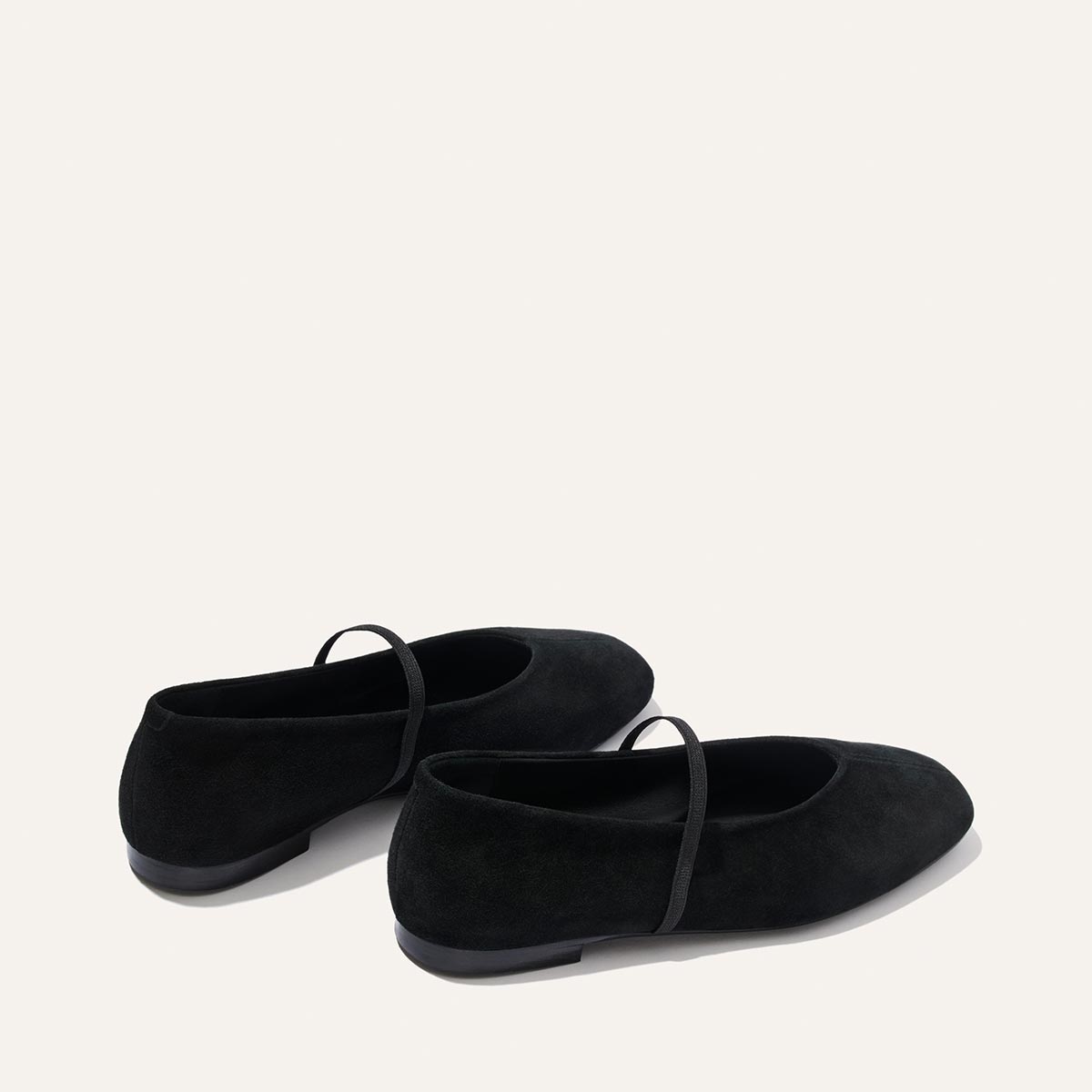 The Phoebe - Black Suede ballet flats in black suede, featuring sacchetto construction and a thin elastic strap across the top.