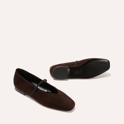 The Phoebe - Espresso Suede by margaux-development: a pair of dark brown suede ballet flats with sacchetto construction and a thin top strap, displayed on a plain light background—one upright, the other on its side.