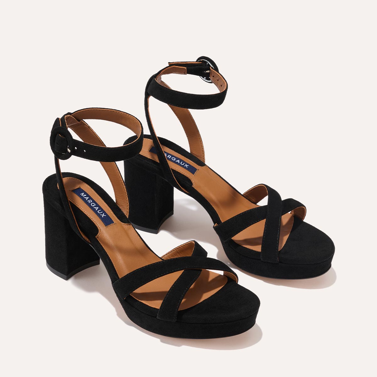 The Platform Sandal in Black Suede, featuring a sleek ankle strap, perfectly placed straps across the toes and a comfortable 3.5-inch block heel.