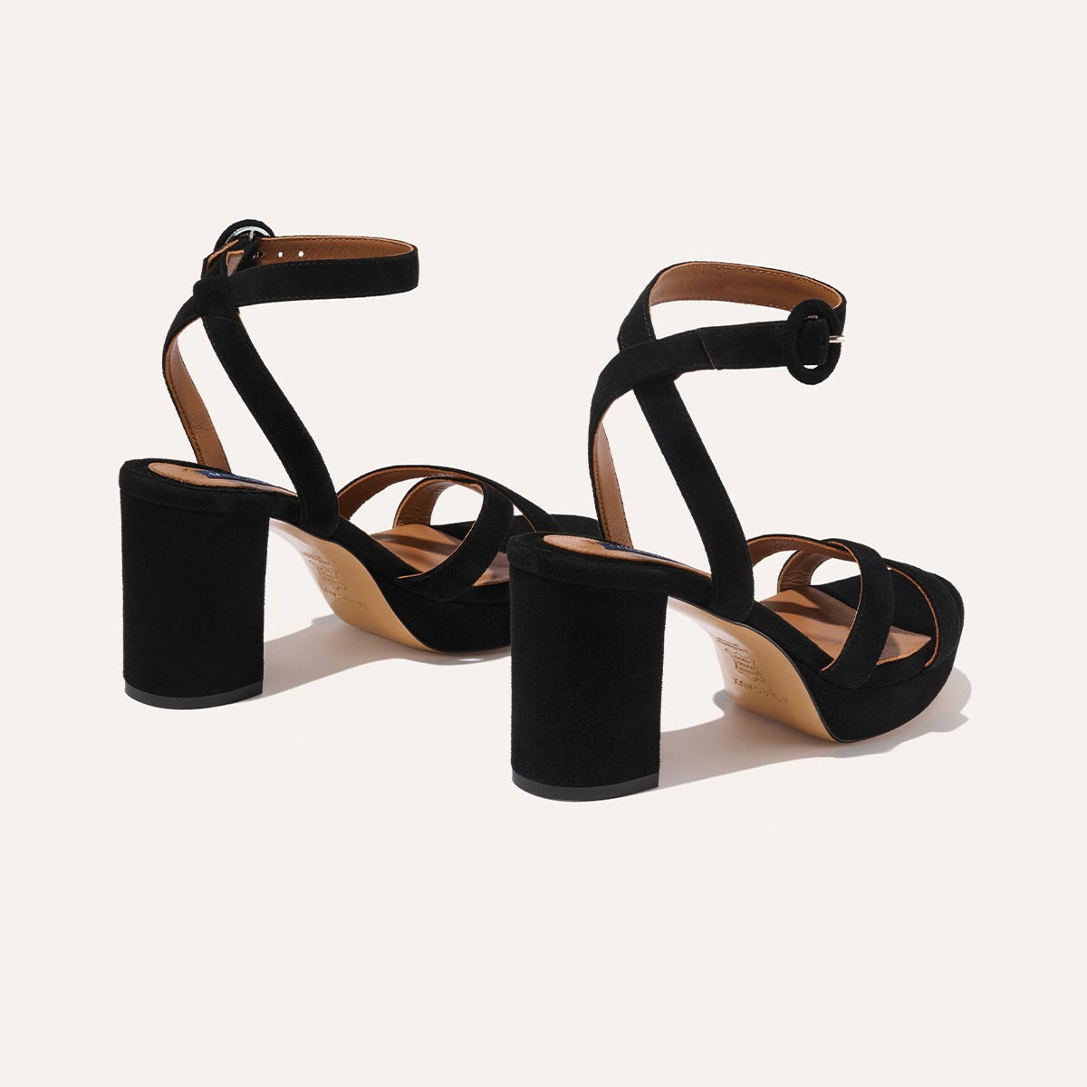 The Platform Sandal in Black Suede, featuring a sleek ankle strap, perfectly placed straps across the toes and a comfortable 3.5-inch block heel.