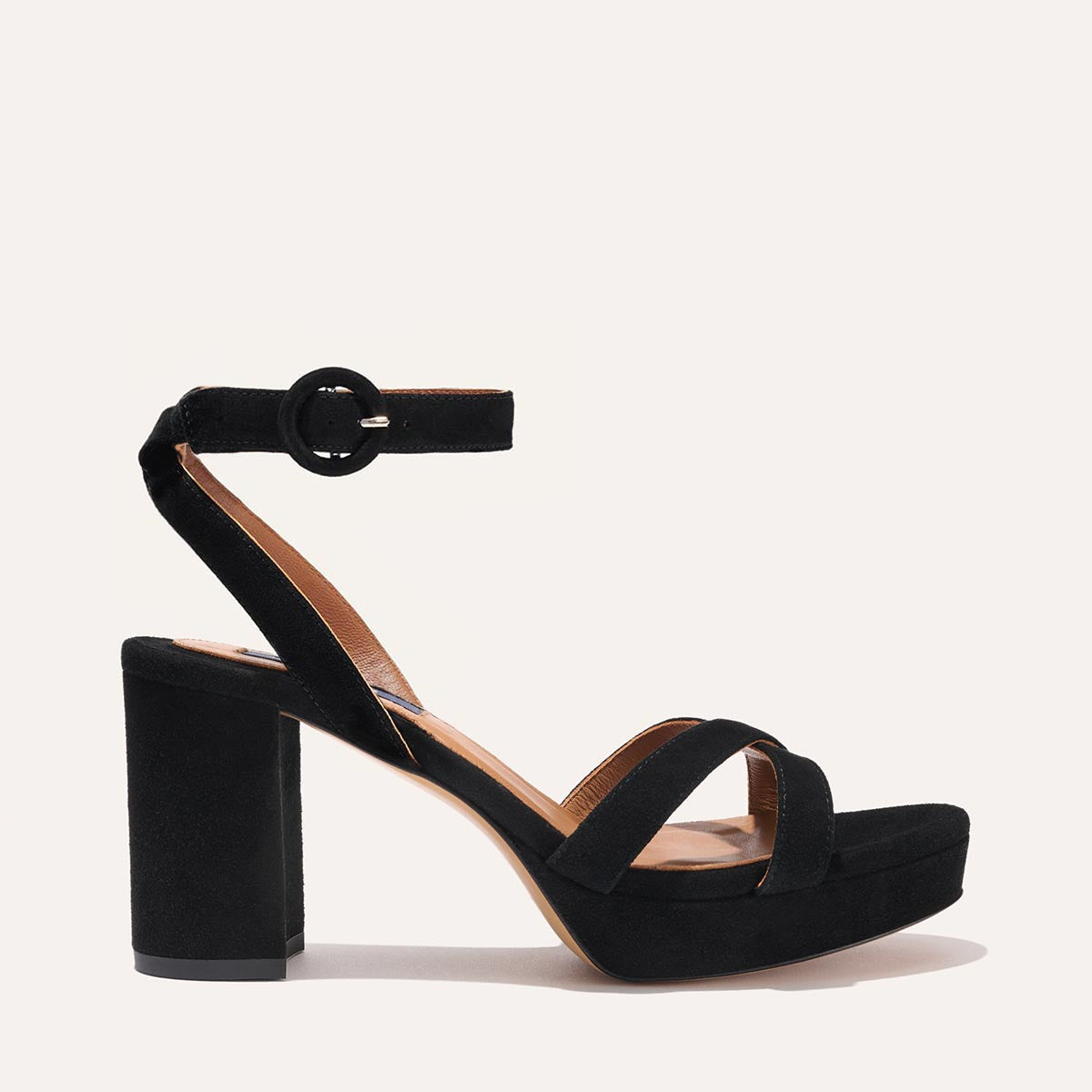 The Platform Sandal in Black Suede, featuring a sleek ankle strap, perfectly placed straps across the toes and a comfortable 3.5-inch block heel.