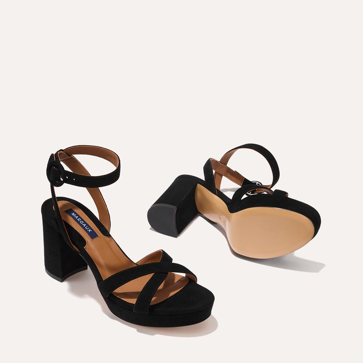 The Platform Sandal in Black Suede, featuring a sleek ankle strap, perfectly placed straps across the toes and a comfortable 3.5-inch block heel.