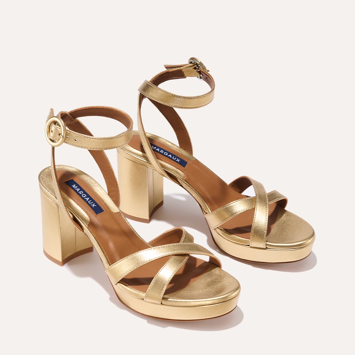 The Platform Sandal in Gold Nappa, featuring a sleek ankle strap, perfectly placed straps across the toes and a comfortable 3.5-inch block heel.