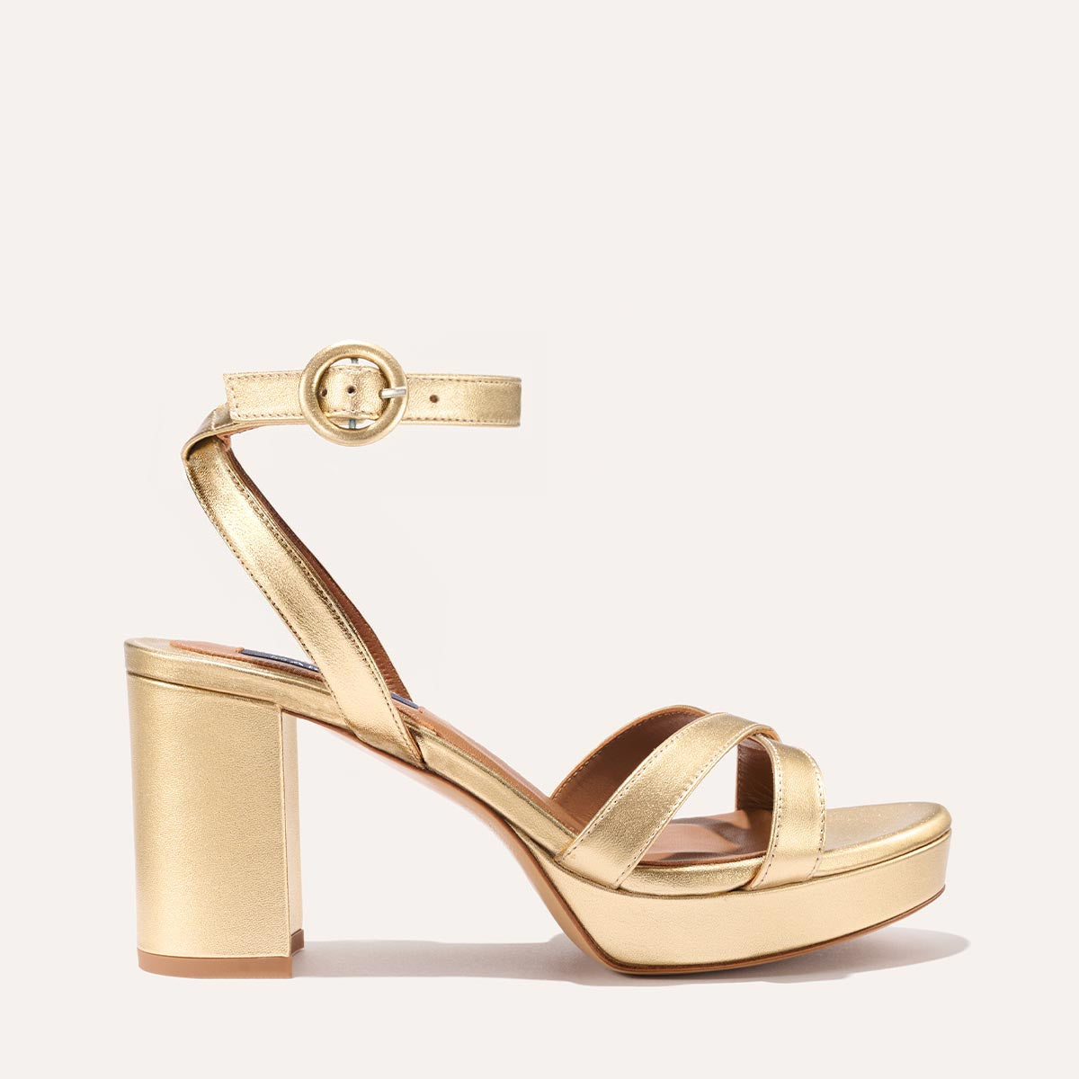 The Platform Sandal in Gold Nappa, featuring a sleek ankle strap, perfectly placed straps across the toes and a comfortable 3.5-inch block heel.