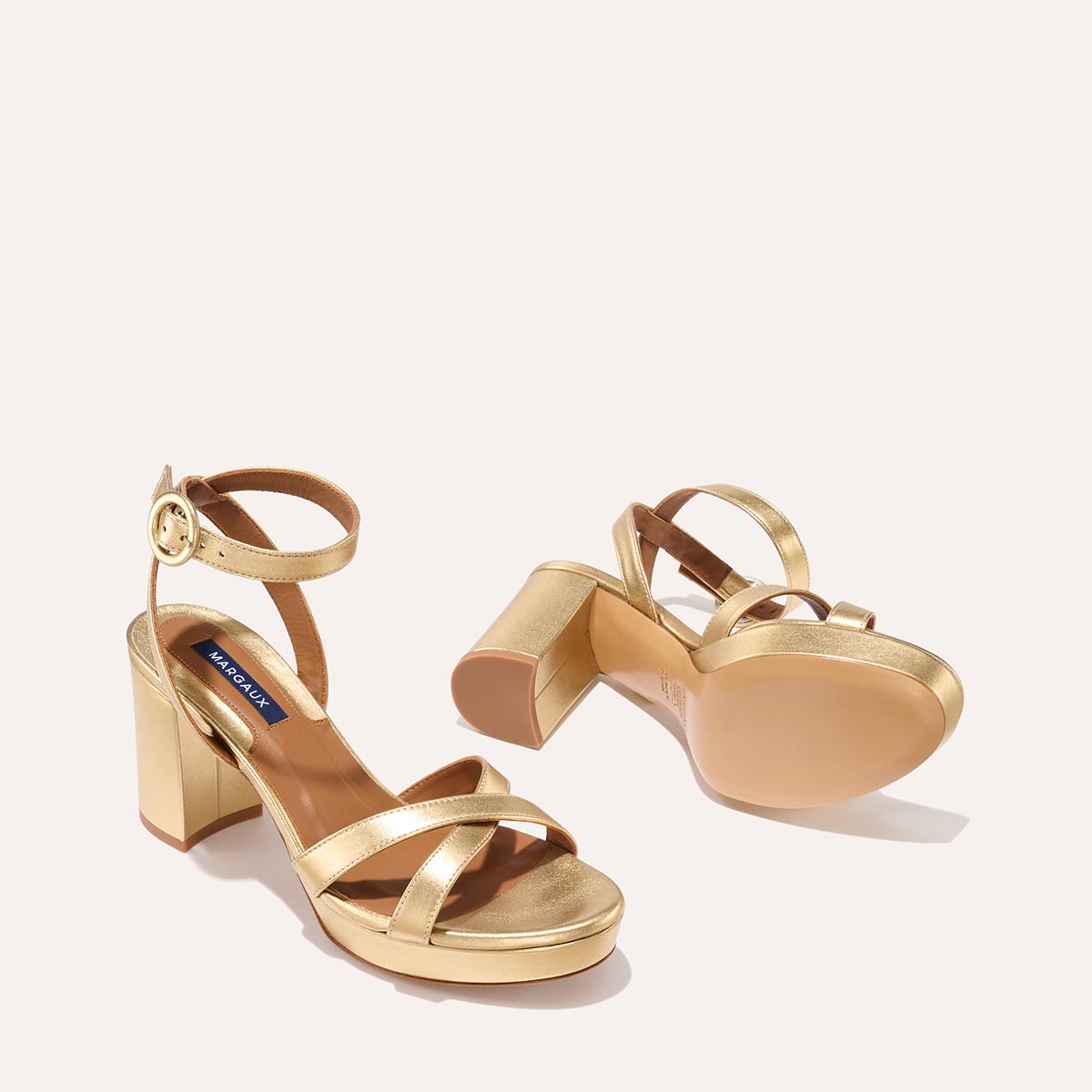 The Platform Sandal in Gold Nappa, featuring a sleek ankle strap, perfectly placed straps across the toes and a comfortable 3.5-inch block heel.