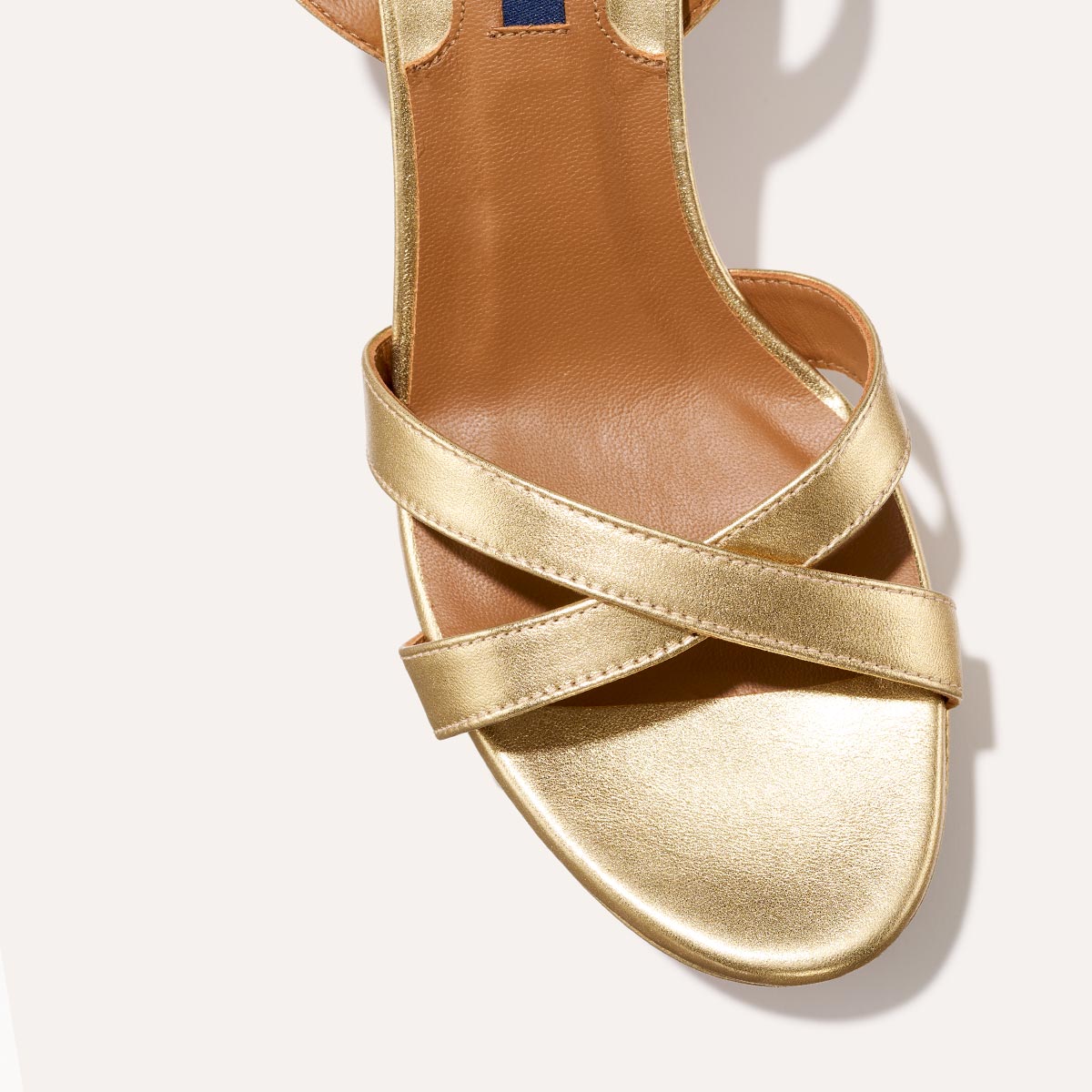 The Platform Sandal in Gold Nappa, featuring a sleek ankle strap, perfectly placed straps across the toes and a comfortable 3.5-inch block heel.