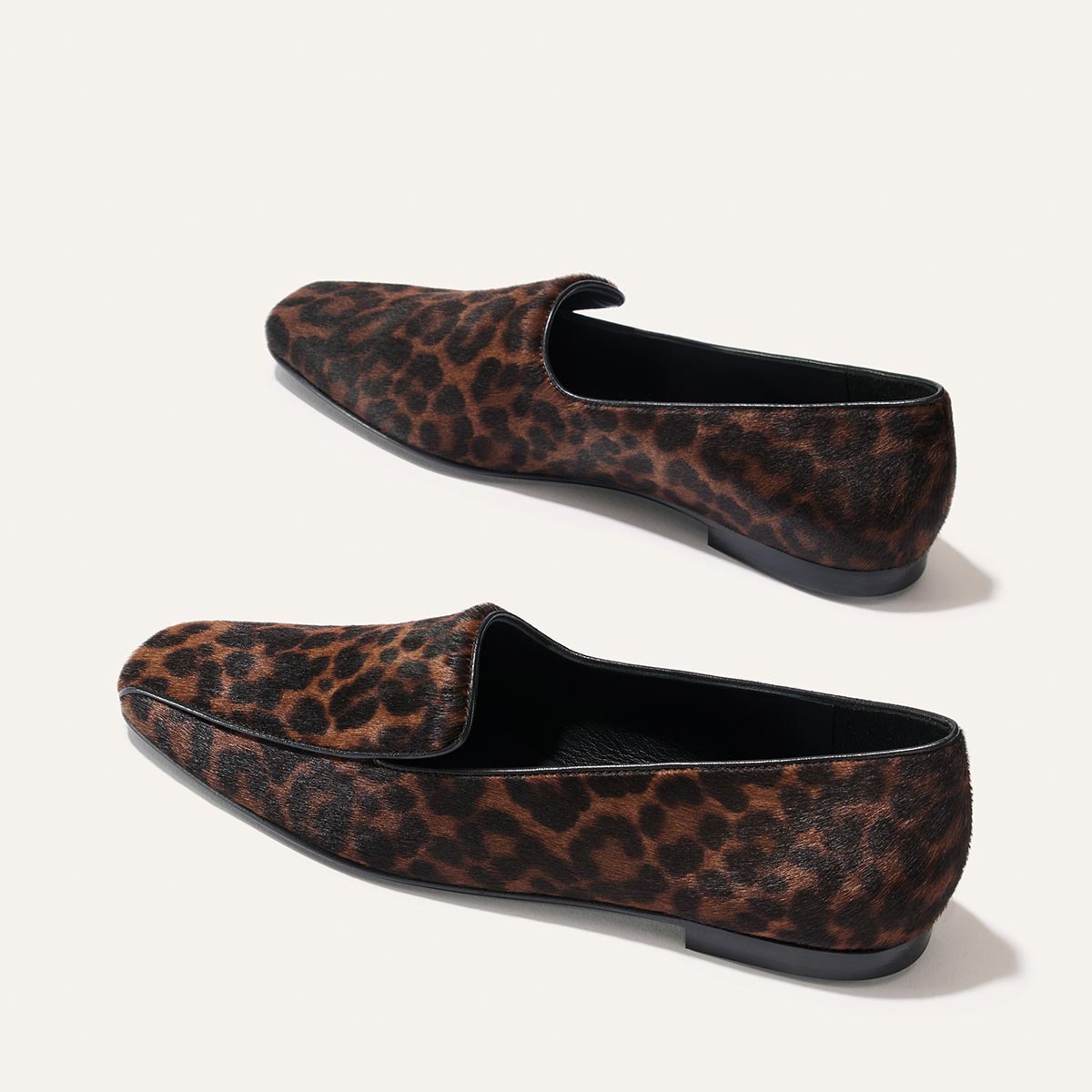 A pair of The Portia Loafer - Chocolate Leopard Haircalf flat loafers featuring a brown and black leopard print pattern.
