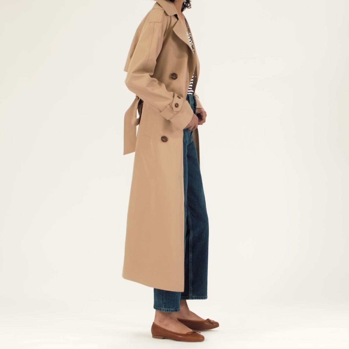 The Demi in Saddle Nappa shown on model styled with straight leg denim, a striped shirt and a tan calf-length trench coat.