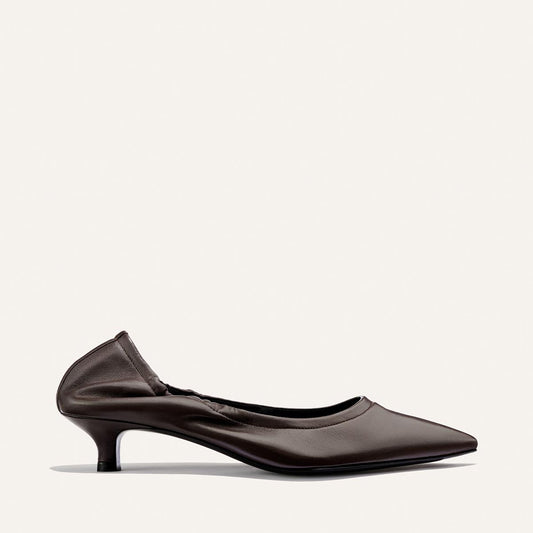 A single chic heel, The Roma 40 in Espresso Nappa by Margaux, features a pointed-toe design and subtle ruched detailing at the back, photographed against a plain light background.