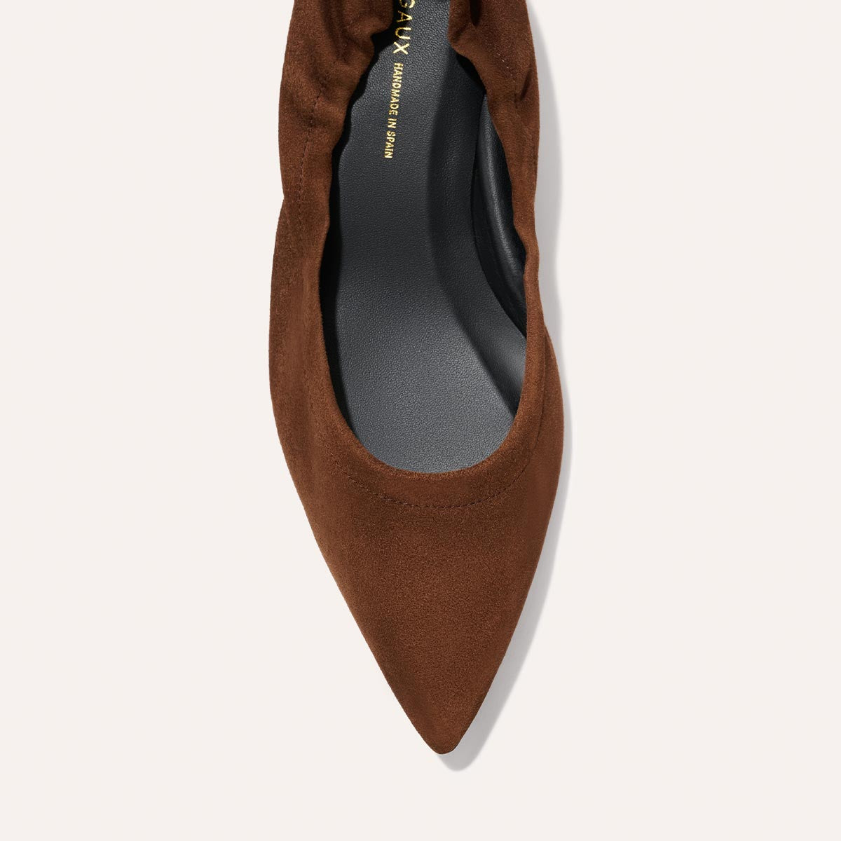 A top view of The Roma 40 - Ganache Suede by Margaux, a chic brown suede pointed-toe flat with gathered detailing and a black insole, set against a light background.