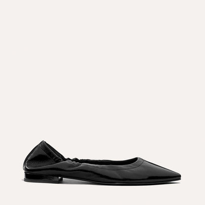 The Roma in Black Crinkle Patent by Margaux—a comfortable pointed-toe ballet flat with a low heel and gathered elastic at the heel—displayed on a light background.