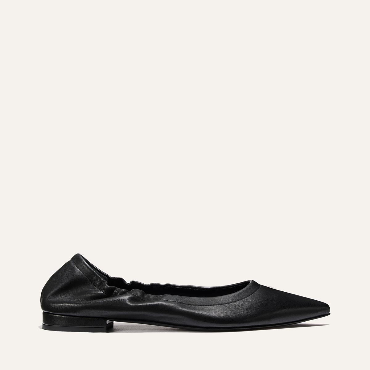 The Margaux Roma - Black Nappa is a black pointed-toe ballet flat with a ruched elastic back and slight heel, shown on a plain light background.