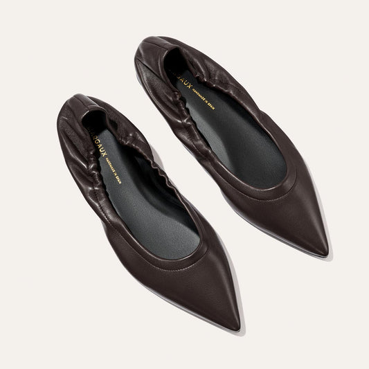 A pair of The Roma - Espresso Nappa pointed-toe ballet flats by Margaux, featuring a sophisticated dark brown hue and elasticized backs, displayed from above on a light background.