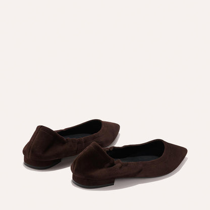 The Roma - Espresso Suede by Margaux: dark brown, pointed-toe suede ballet flats with subtle ruching at the heel, shown on a light neutral background.