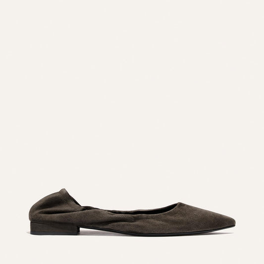 A single Margaux “The Roma - Graphite Suede” ballet flat, featuring dark graphite suede, a pointed toe, low heel, and slightly gathered detailing, displayed on a plain light background.