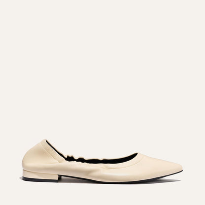 The Roma - Ivoire Nappa by Margaux is a single cream-colored pointed-toe ballet flat with a low square heel and gathered detailing, displayed on a plain light background.