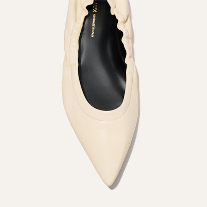 Top view of The Roma - Ivoire Nappa by Margaux: a sophisticated cream ballet flat with a pointed toe, gathered ruched edge, and black insole.