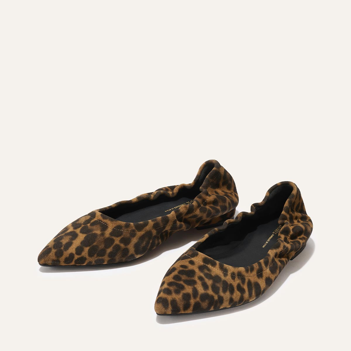 The Roma - Leopard Suede by Margaux is a classic pointed-toe ballet flat with a brown and black leopard print on a light suede background, blending timeless style and comfort.