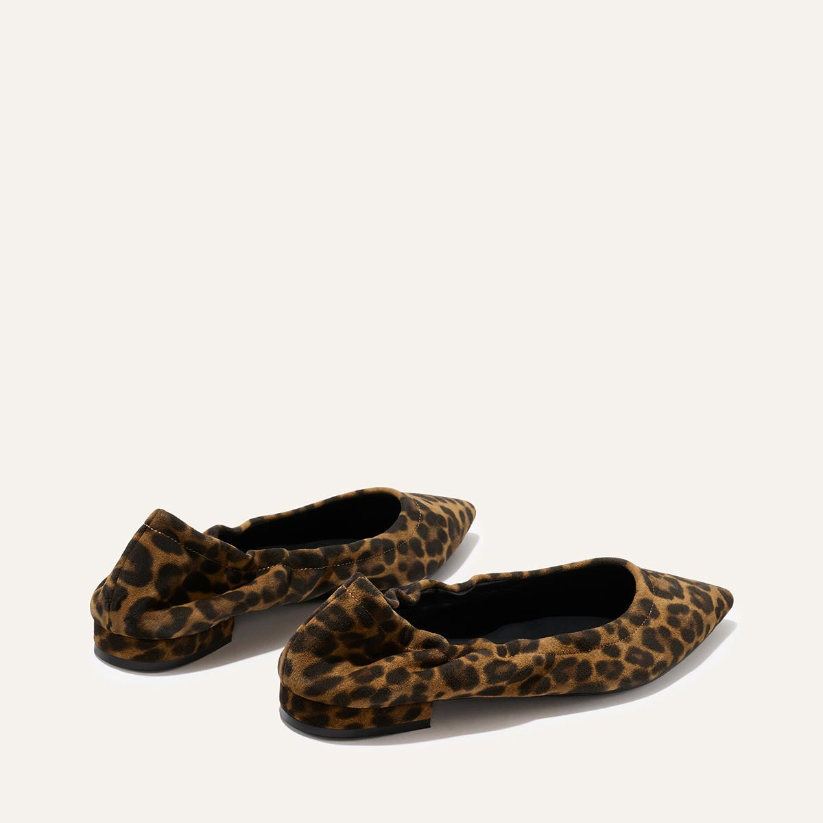 The Roma - Leopard Suede by Margaux are pointed-toe ballet flats with a brown and black leopard print and bow detail at the back, shown on a plain light background.