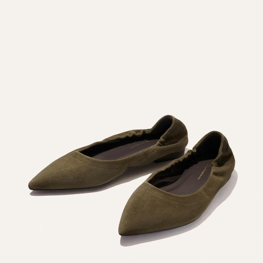 A pair of Margaux's The Roma - Moss Suede pointed-toe ballet flats with ruched heel detail, displayed on a plain, light background.