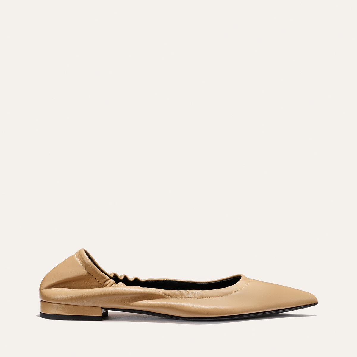 The Roma - Praline Nappa by Margaux is a tan, pointed-toe flat with a ruched heel and low square heel, shown against a plain light background.