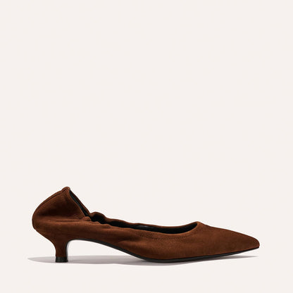 The Roma 40 - Ganache Suede by Margaux is a brown suede kitten heel with a pointed toe and gathered edge detail, shown on a plain light background.