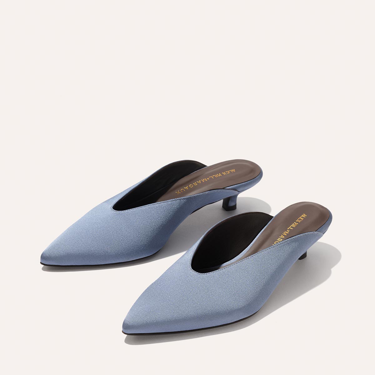The Margaux Alex Mill x Margaux: The Romy in Slate Blue Satin—pointed-toe kitten mule heels—offers comfort and style, perfect as a party shoe, shown on a neutral background.