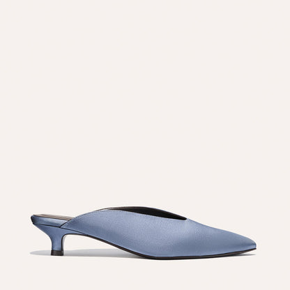 The Alex Mill x Margaux: The Romy - Slate Blue Satin by Margaux, featuring a pointed toe and low heel, is shown on a neutral background—a stylishly comfortable party shoe.
