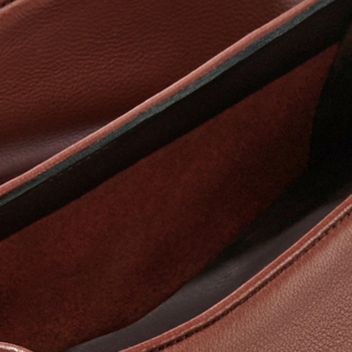 Close-up of The Salamanca - Brandy Nappa by Margaux, highlighting its textured leather exterior and buttery soft leather lining.