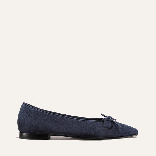 The Salamanca - Vintage Navy Suede flat in navy blue suede with a pointed toe, small bow detail, unlined construction, and a low heel.