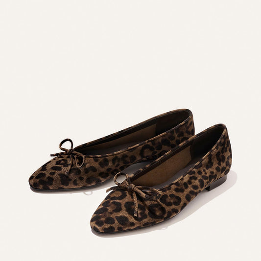 The Salamanca - Brown Leopard Suede by Margaux features pointed-toe flats in leopard-print suede with delicate bows, crafted from buttery soft leather and photographed on a light background.