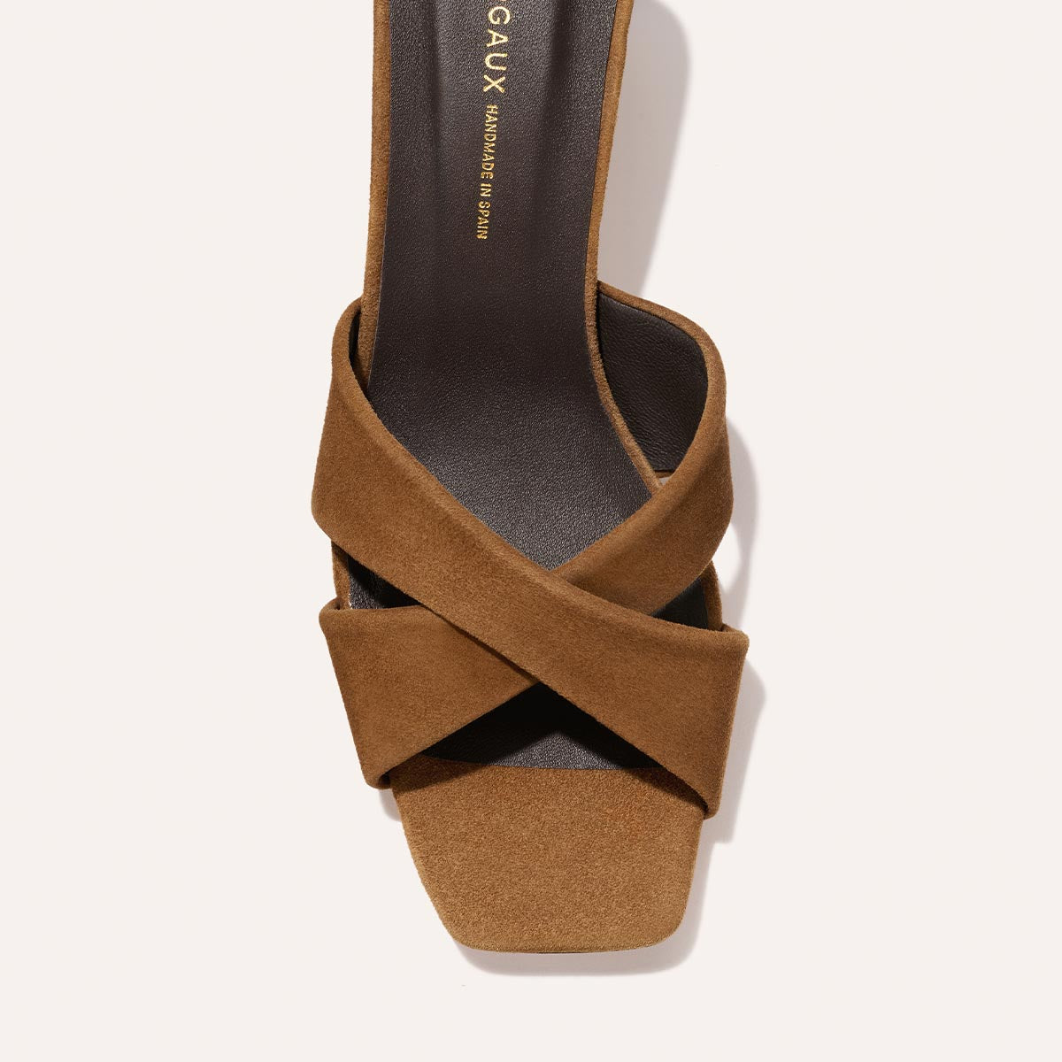 Top view of The Selene 50 in Nutmeg Suede by Margaux—a brown suede slip-on heeled sandal with wide crisscross leather straps and a square toe, shown on a light background.