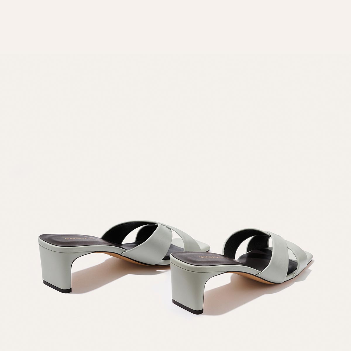 Margaux Selene 50 - Sky Nappa light blue mule sandals featuring crossed straps, a low block heel, and a padded insole.
