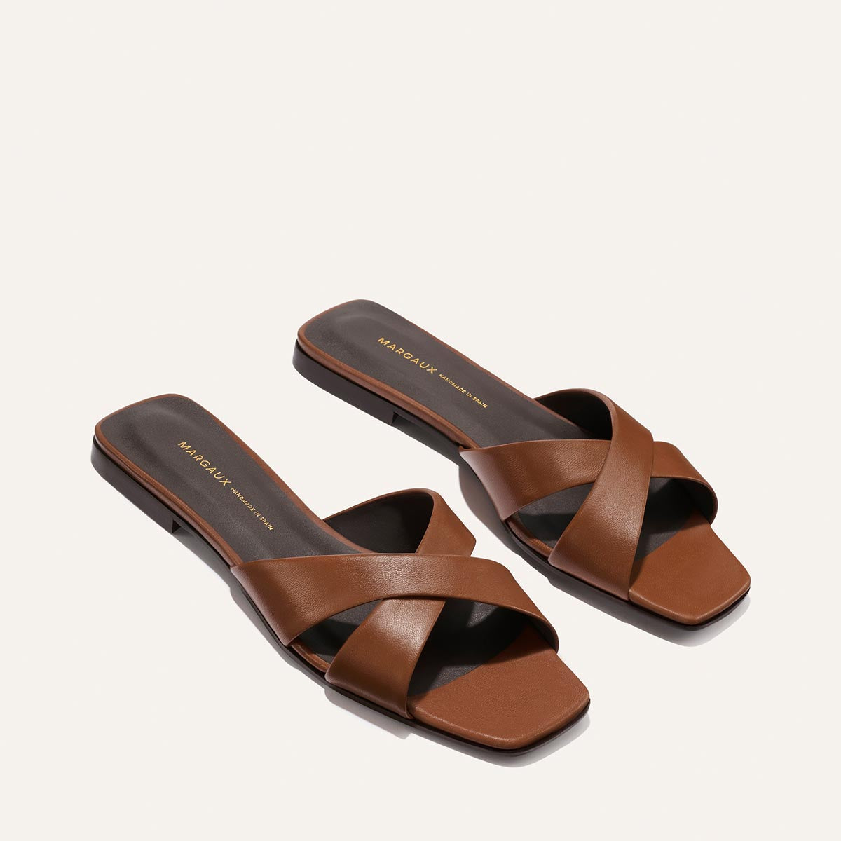 Pair of brown sandals on a white background